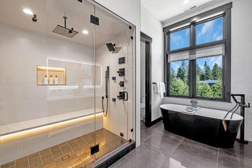 a bathroom with a tub and a shower with a window at Grand Retreat in Cle Elum