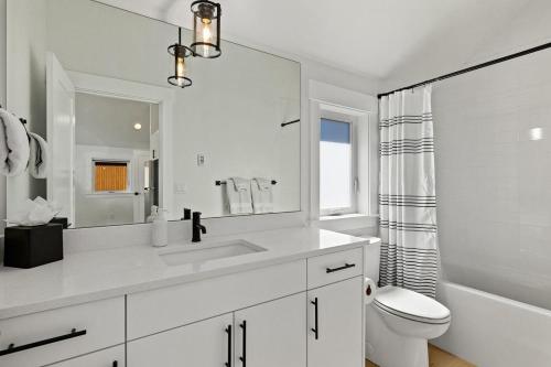 a white bathroom with a sink and a toilet at Sun Seeker in Cle Elum