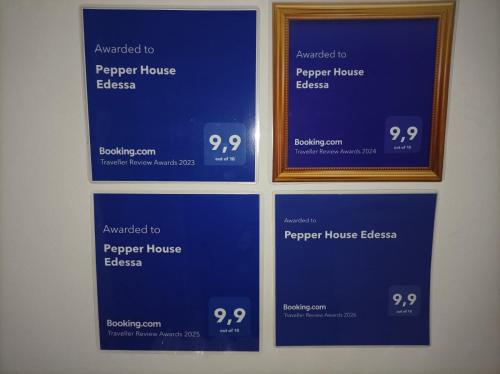 a picture of two blue signs on a wall at Pepper House Edessa in Edessa