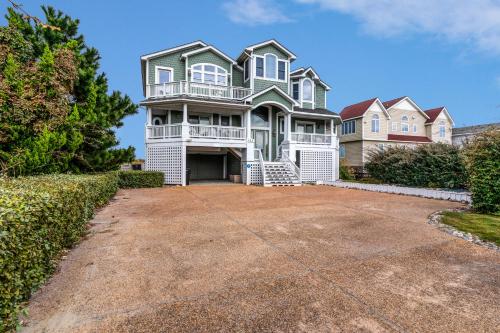 a large house with a large driveway at 2869 - Seascape in Duck