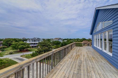 a large deck with a blue house at 3213 - Seaside Salvation in Duck