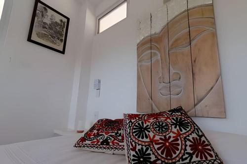 a room with two pillows and a wooden wall at Valentina Salchi suites virgin beaches internet in Cuatunalco
