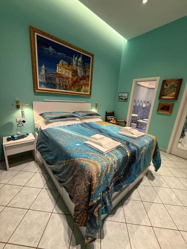 a bedroom with a bed with a painting on the wall at The Rooftop Terrace b&b Two Double Rooms with private bathrooms and an equipped roof terrace in Sant'Agnello