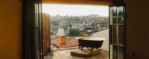 a bathroom with a tub and a view of a city at Casa Chichipicas Hotel Boutique in Valle de Bravo