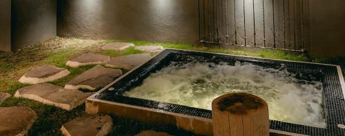 a bath tub filled with water in at Casa Chichipicas Hotel Boutique in Valle de Bravo