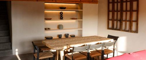 a dining room with a wooden table and chairs at Casa Chichipicas Hotel Boutique in Valle de Bravo