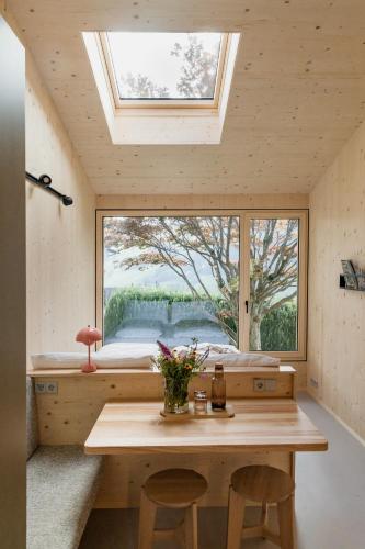 a room with a table and a large window at biYou Ecoquartier in den Bergen in Schladming