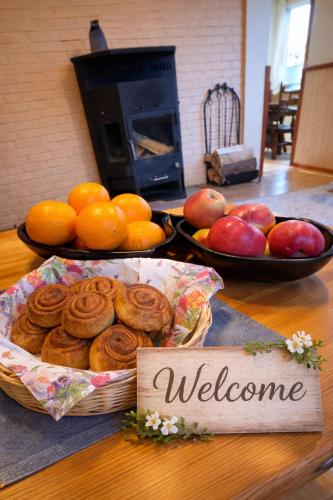 a table with a basket of fruit and a welcome sign at Puhkepesa 6 in Otepää