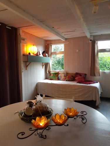 a room with a table with two beds and a bed at Chalet Zen dans les landes in Castets