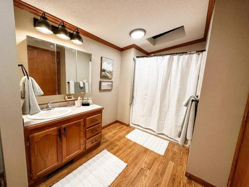a bathroom with a sink and a large window at Blue Ribbon Cabin in Farwell