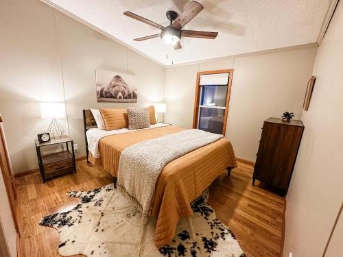 a bedroom with a bed and a ceiling fan at Blue Ribbon Cabin in Farwell