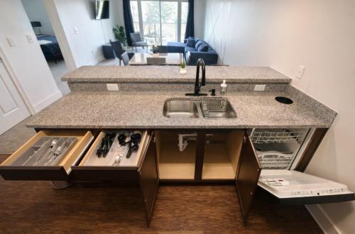 a kitchen with a sink and a counter at Designer UAB Condo King Bed Balcony View 2 in Birmingham