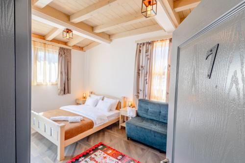 a bedroom with a bed and a blue chair at River Bridge in Žabljak
