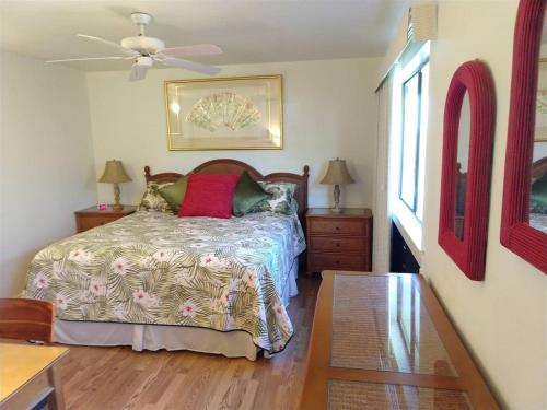 a bedroom with a bed and a ceiling fan at Unit 17 Large 1 Bed 1 Bath Condo Ocean Views in Pahala