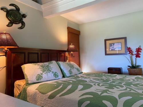 a bedroom with a bed with two pillows on it at Unit 18 Relaxing Oceanview Studio in Pahala