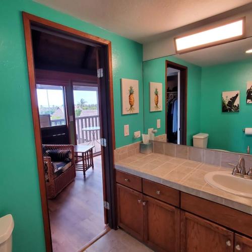a bathroom with a sink and a mirror at 58 2 bedroom 2 bath in Pahala