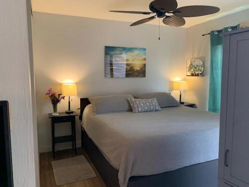 a bedroom with a bed with a ceiling fan at 41 Turtle Hut in Pahala