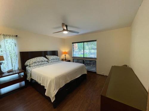 a bedroom with a bed and a ceiling fan at 37 1 Bed 1 Bath with Ocean Views in Pahala