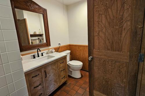 a bathroom with a sink and a toilet and a mirror at 37 1 Bed 1 Bath with Ocean Views in Pahala