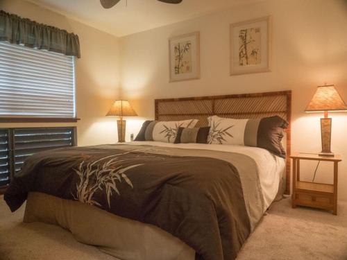 a bedroom with a large bed and a window at 54 Old Hawaii Charm Condo in Pahala