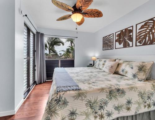 a bedroom with a bed and a ceiling fan at 57 Beautiful Remodeled Studio in Pahala