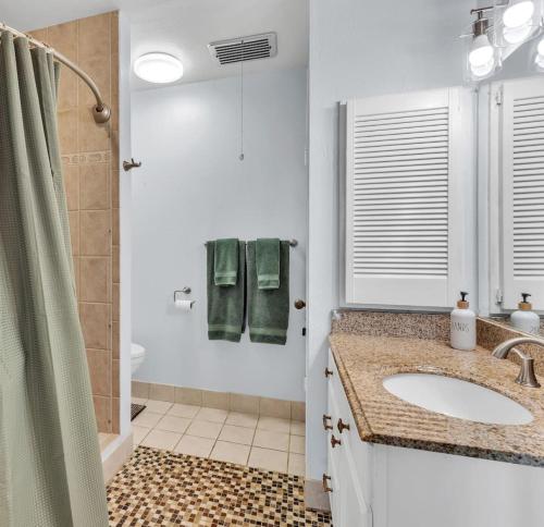 a bathroom with a sink and a shower at 57 Beautiful Remodeled Studio in Pahala