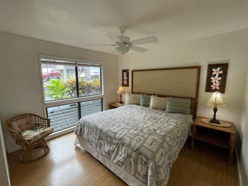 a bedroom with a large bed and a window at 16 Two Bedroom Two Bath Condo in Pahala