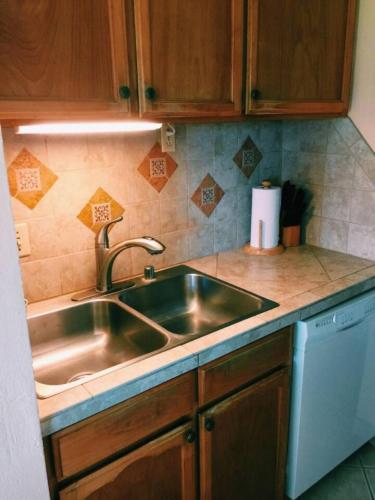 a kitchen with a stainless steel sink and a dishwasher at 16 Two Bedroom Two Bath Condo in Pahala