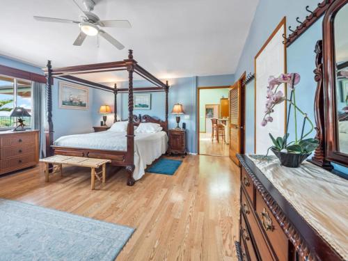 a bedroom with a bed and a ceiling fan at Honu Harbor with Pool on Golf Course in Naalehu