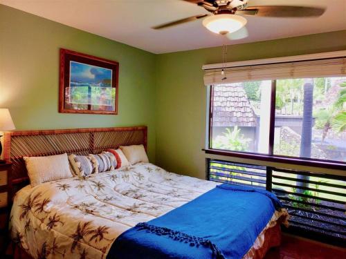 a bedroom with a bed and a large window at Unit 26 King Bed and Ocean View in Pahala
