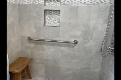 a shower in a bathroom with a tiled shower at Unit 05 Well Maintained Studio in Pahala