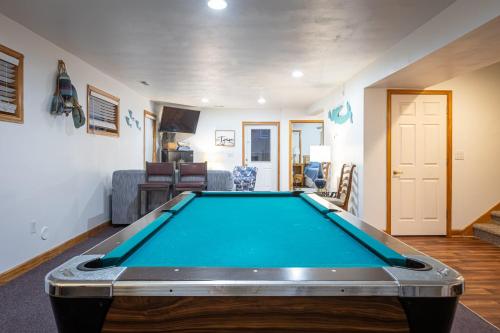 a pool table in the middle of a living room at 5195 - Captain's Choice in Kill Devil Hills