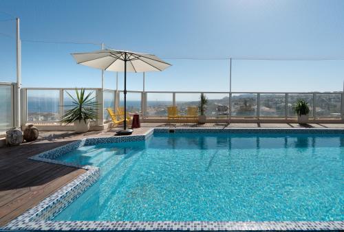 a swimming pool on top of a building at Kedem Eilat קדם אילת in Eilat