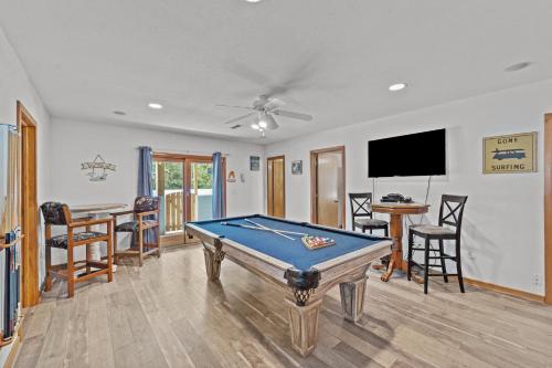 a living room with a pool table and a tv at 1090 - Catch Me N Corolla in Corolla
