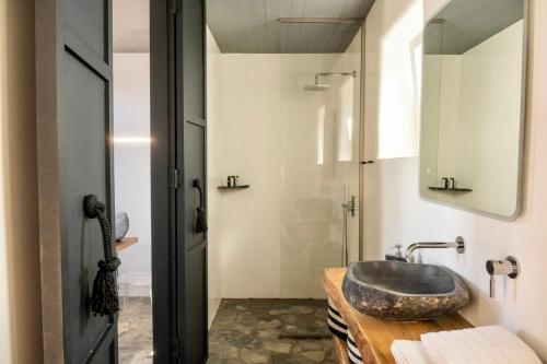 a bathroom with a sink and a shower at Mykonos Dot Art Homes in Ano Mera