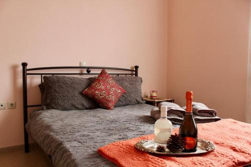 a bed with a bottle of wine and a plate of food at Arcadia di Vito in Tripoli