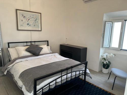 a bedroom with a bed and a chair at Casa Santo Antonio in Pias