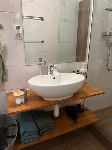 a bathroom with a sink and a mirror at Victory apartmán in Šamorín