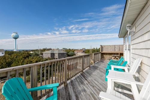 a deck with chairs and a water tower at 7030 - Waves Against the Machine in Rodanthe