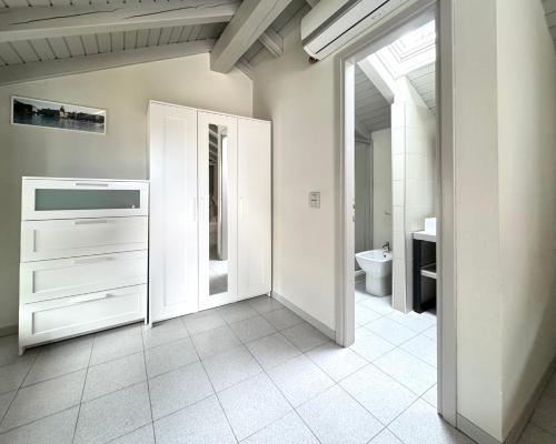 a white bathroom with a sink and a toilet at IRIS 1 lago di Como in Dongo