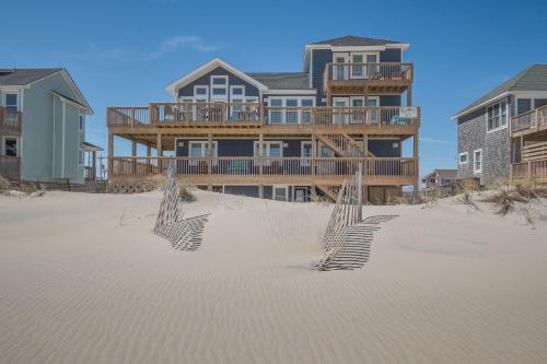 a large house on the beach with a sand trap at 7677 - Weathering Heights in Avon