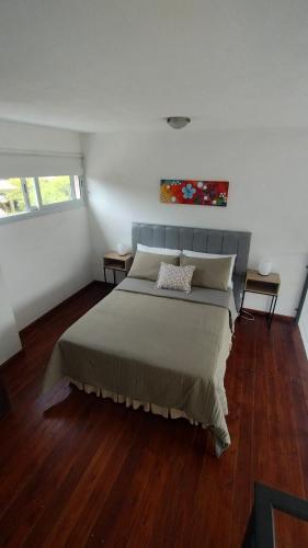 a bedroom with a large bed in a room at Paititi Loft - Solo Adultos in Villa Carlos Paz