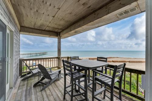 a porch with a table and chairs and the ocean at 7660 - Robyn's Nest in Avon