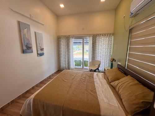 a bedroom with a large bed and a window at River Breeze Cherai in Cochin