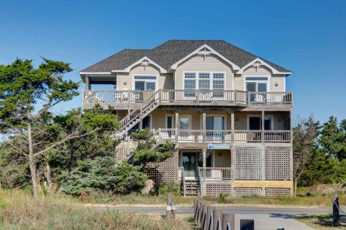 a large house on the beach with trees at 7678 - Drumstick in Avon