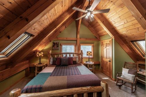 a bedroom with a bed and a ceiling fan at Shady Maples Lodge in Townsend