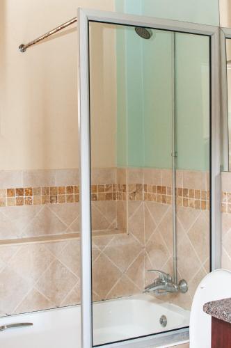 a shower with a glass door in a bathroom at Ocean View Villas B09 in Port Edward
