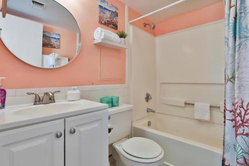 a bathroom with a sink and a toilet and a mirror at The Palace Resort #1114 in Myrtle Beach