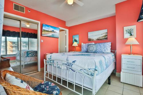 a bedroom with red walls and a bed and a chair at The Palace Resort #1114 in Myrtle Beach