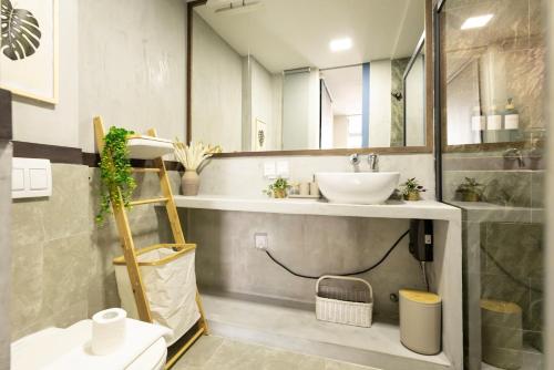 a bathroom with a sink and a mirror at Cozy 1BHK Apartment in Central Malé in Male City